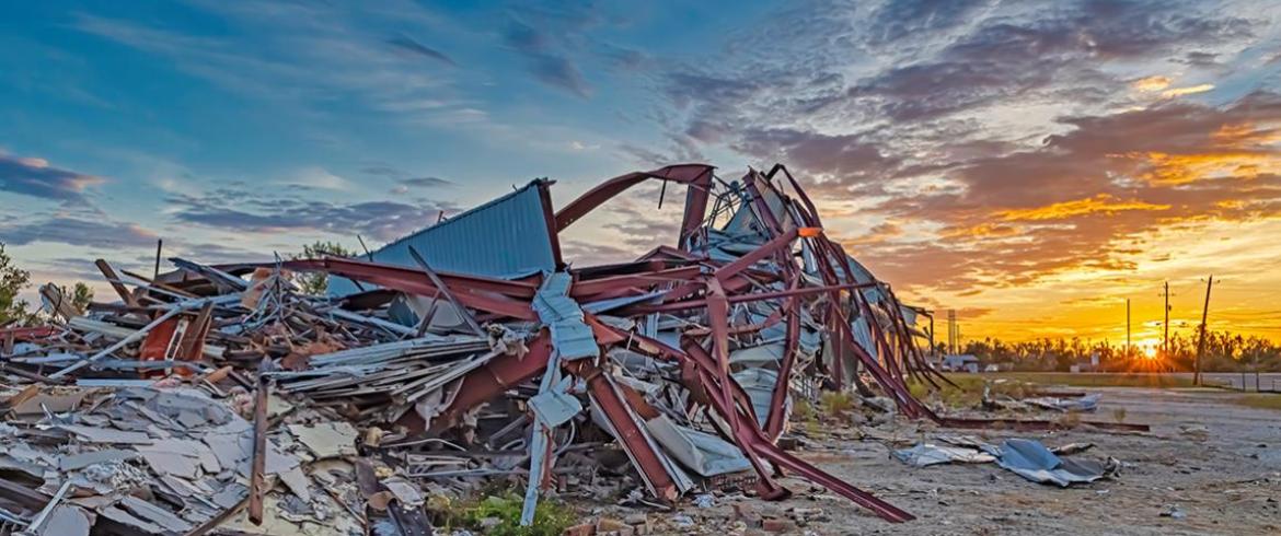 photo of building destroyed by hurricane at sunset