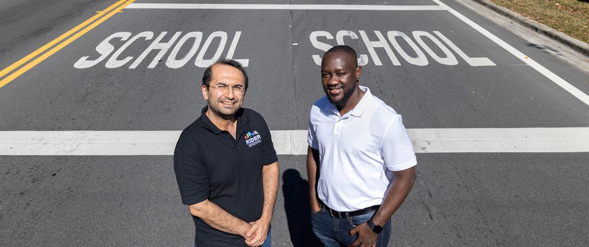 photo of two men standing in a school zone 