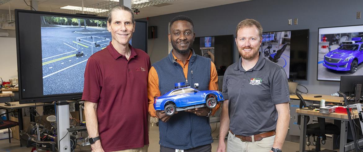 photo of anubi team with scale car in lab